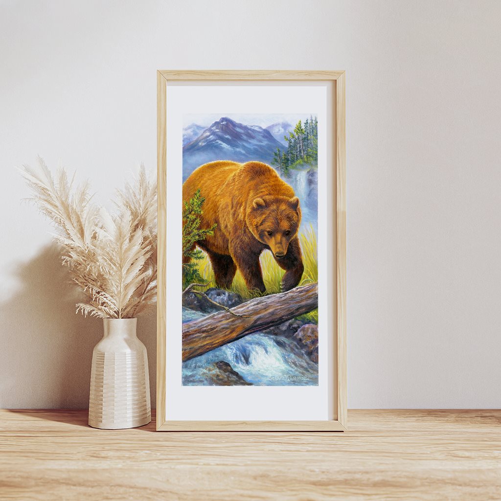 Alaskan Grizzly Bear Giclée Art Print "I See You" in example wood frame, resting on a table. By artist Jeanne Warren.