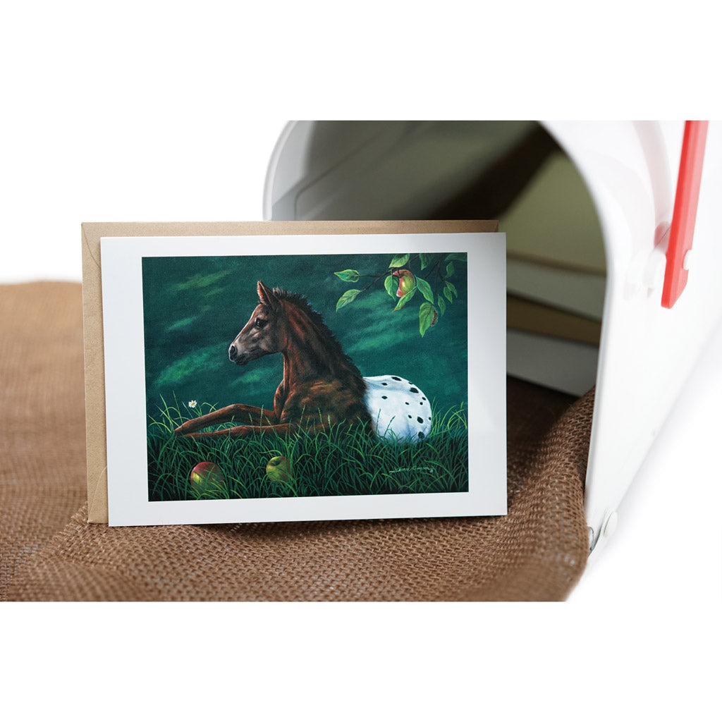 Apple Loosa - Spotted Appaloosa colt resting under apple tree with fallen fruit and daisy in tranquil nature scene