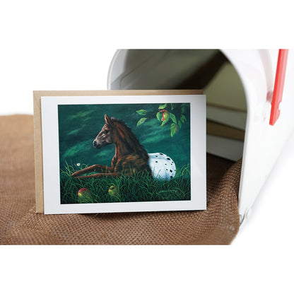 Apple Loosa - Spotted Appaloosa colt resting under apple tree with fallen fruit and daisy in tranquil nature scene