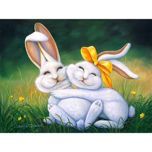 A pair of smiling white buck and doe bunnies, snuggling up for Easter in yellow ribbon and bright yellow flowered grass. By artist Jeanne Warren