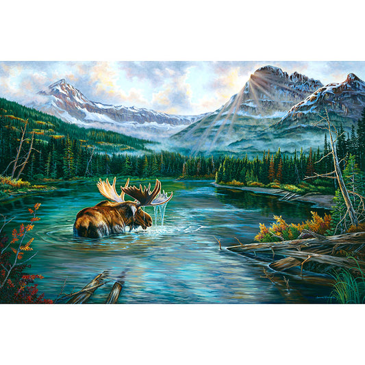 A trophy size bull Moose wading through a lake in the midst of wilderness mountains in Glacier National Park. By Artist Jeanne Warren.